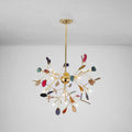 A vibrant gold-toned decorbites modern colorful island light fixture with leaf-shaped glass and warm color temperature