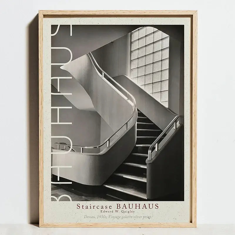 A framed black and white modern geometric bauhaus wall art print featuring a minimalist staircase and vertical bauhaus lettering