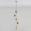 DecorBites™ modern gold linear chandelier with four smoke gray glass shades on a slender metal rod hanging fixture