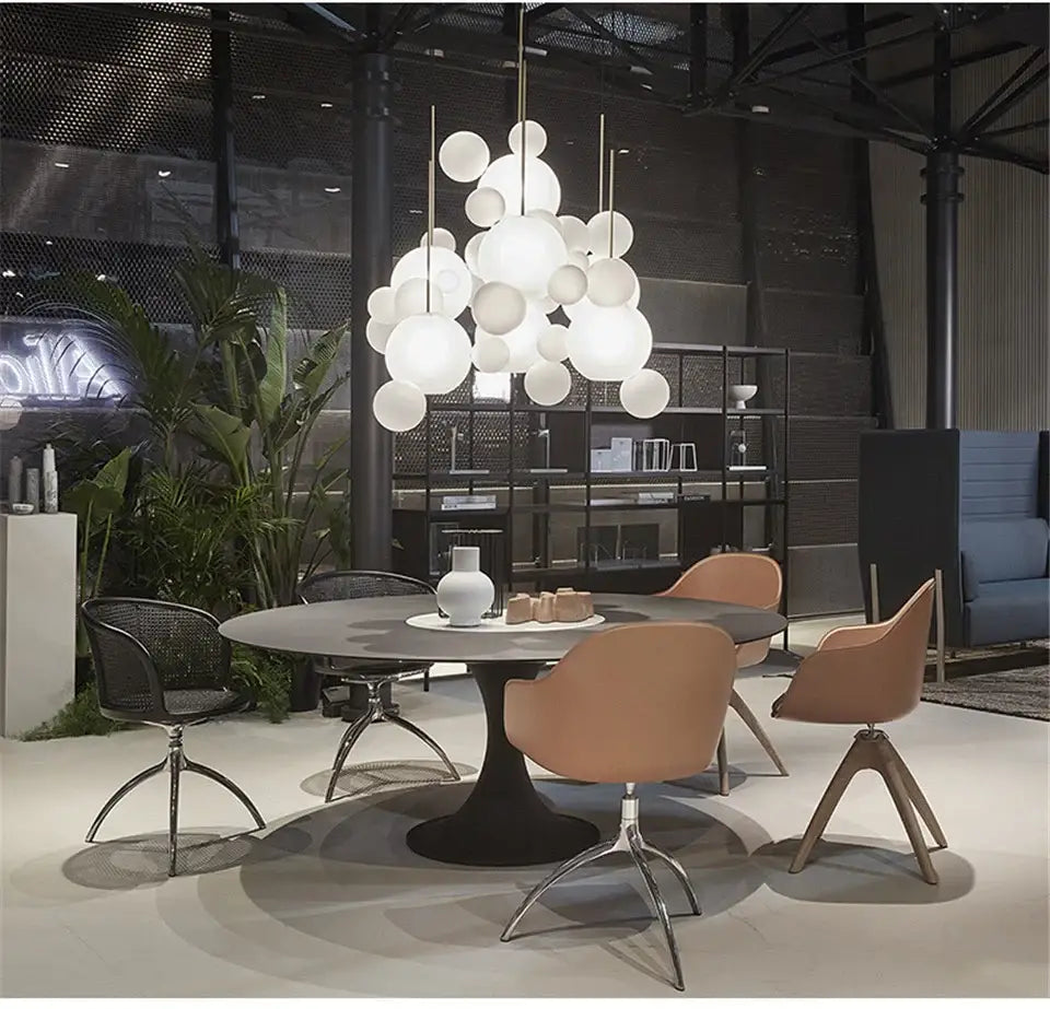 Modern white spherical led bubble ball pendant light fixture hanging above a dining table for living room decor