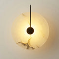 Warm-toned circular onyx marble wall lamp with sleek black metal arm from decorbites modern marble wall collection