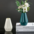 Modern nordic diamond shaped teal ceramic flower vase holding white flowers and greenery by DecorBites™