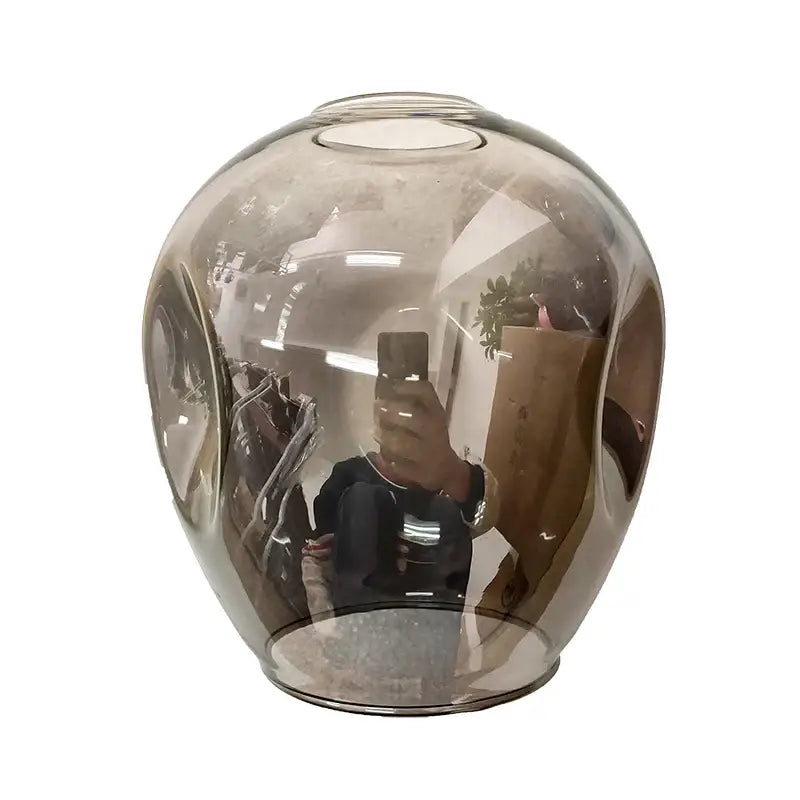 A sleek translucent amber glass ball led vase with a rounded bulbous shape in decorbites modern nordic glass ball chandelier
