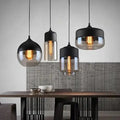 Set of three DecorBites modern nordic pendant lighting with black metal shades and clear glass globes housing filament bulbs