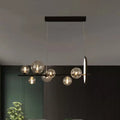 DecorBites™ modernist black metal island light with seven clear glass globe bulbs and circular hanging pendant design
