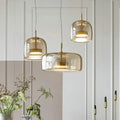 DecorBites™ moroccan amber modern nordic pendant light with translucent amber glass shades and brass accents hanging
