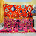 Vibrant orange and pink moroccan handmade beni ouarain rug with intricate blue white and black geometric patterns 3m x 2.5m