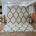 Cream-colored moroccan handmade beni ouarain rug 3m x 2m with bold black diamond lattice pattern and fringed edges