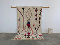 Beige moroccan handmade azilal rug with bold red blue and purple geometric patterns in pure natural wool 265x161 cm