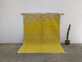 Vibrant yellow moroccan handmade traditional azilal rug with textured honeycomb pattern and natural fiber fringe