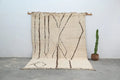 Beige beni ouarain rug with dark brown geometric patterns and fringed edges from decorbites™ handmade collection