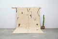 Cream-colored moroccan handmade beni ouarain rug with black geometric patterns and fringed edges 300 x 200 cm