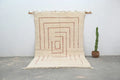 Cream-colored beni ouarain rug with geometric red-brown pattern and fringed edges moroccan handmade wool decor