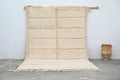 Cream-colored handwoven beni ouarain rug with chunky knit texture and fringed edges by DecorBites™ 303 x 205 cm
