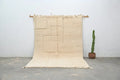 Beige wool beni ouarain rug with geometric pattern and fringed edges from decorbites™ measuring 307 x 205 cm