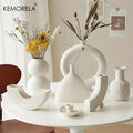 White ceramic nordic ceramic vase with minimalist sculptural design smooth surface for home decor accent by DecorBites