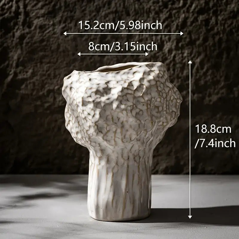 White ceramic nordic ceramic vase by DecorBites with textured organic surface and vertical ridges on base with pampas grass