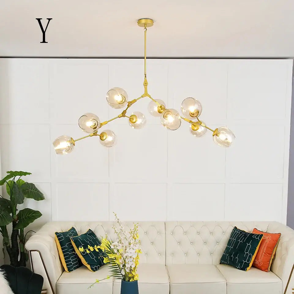 Gold-toned decorbites™ nordic chandelier with clear glass globe bulbs in a branching design for living rooms and dining rooms