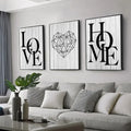 Three framed black-and-white canvas prints by DecorBites featuring nordic diamond heart and word art on wood backgrounds