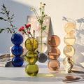 Stacked vibrant translucent blue green amber and clear nordic glass vases from decorbites™ nordic glass vase collection
