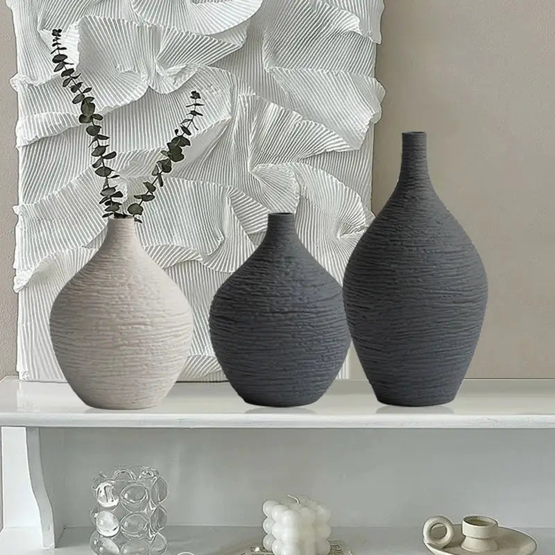 Three textured nordic luxury ceramic vases in gray and beige with unique ribbed surface designs for home décor