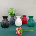 Set of five DecorBites™ ceramic flower vases in black gray white red and teal with ribbed textures in Nordic style