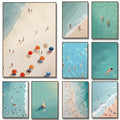 Set of eight DecorBites™ wall art prints featuring vibrant turquoise waters and beach umbrellas in a minimalist style