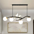 Black wrought iron DecorBites™ island lamp tree with three white glass globes and two ceramic doves on lamp tree branch