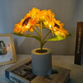 DecorBites™ rechargeable sunflower led night light with glowing yellow petals and light blue cylindrical pot