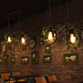 DecorBites™ retro metal bicycle restaurant ceiling light with black wrought iron frames, exposed bulbs, and plant decor