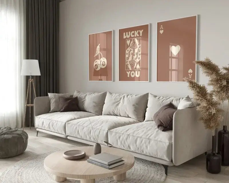 Light gray upholstered sectional sofa with metal legs and dark brown throw pillows below decorbites retro queen of hearts wall art posters