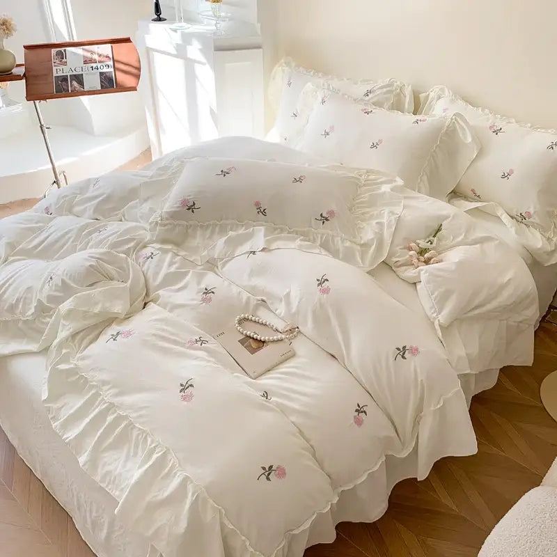 Cream-colored decorbites™ rose embroidered duvet set with delicate pink green floral embroidery and ruffled edges
