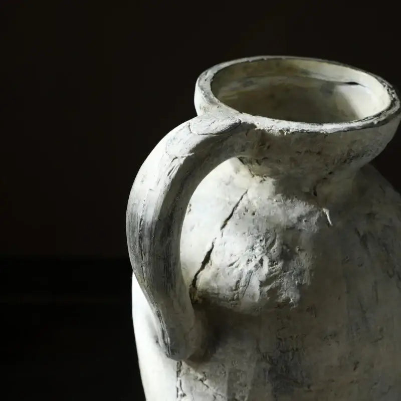 Weathered white rustic handmade ceramic vase with sturdy handle and visible cracks for home decor by DecorBites