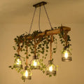 Rustic wooden brown island light with five cage shade lanterns and green art ivy pendant by DecorBites