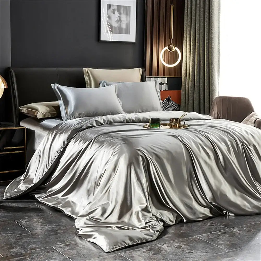 Silver satin 3 pcs duvet cover set from decorbites silk bedding set draped over a width bed in modern bedroom