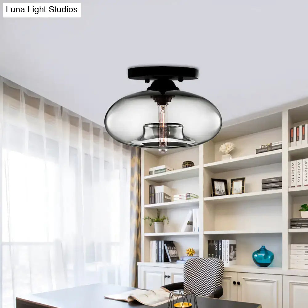 Modern black decorbites flush mount with a sleek glass oval flush shade and exposed filament bulb for hallway lighting