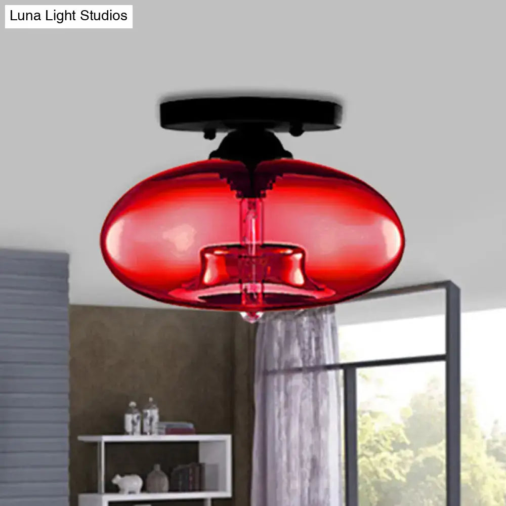 Vibrant red translucent glass oval flush mount pendant light with sleek black base for hallway ceiling fixture