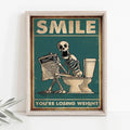 A framed decorbites skeleton man squatting toilet canvas wall art with vintage teal background and weight loss text