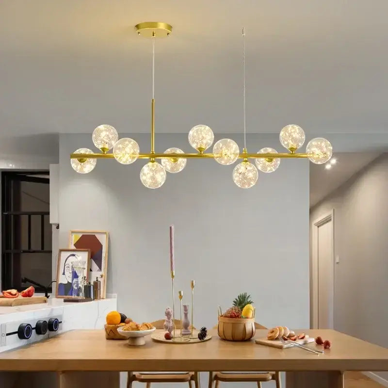Gold-toned decorbites sleek glass ball chandelier with frosted globe bulbs in linear design for dining room lighting