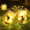 Glass mason jar solar lanterns with fairy silhouettes and warm yellow led lights for garden decoration by decorbites