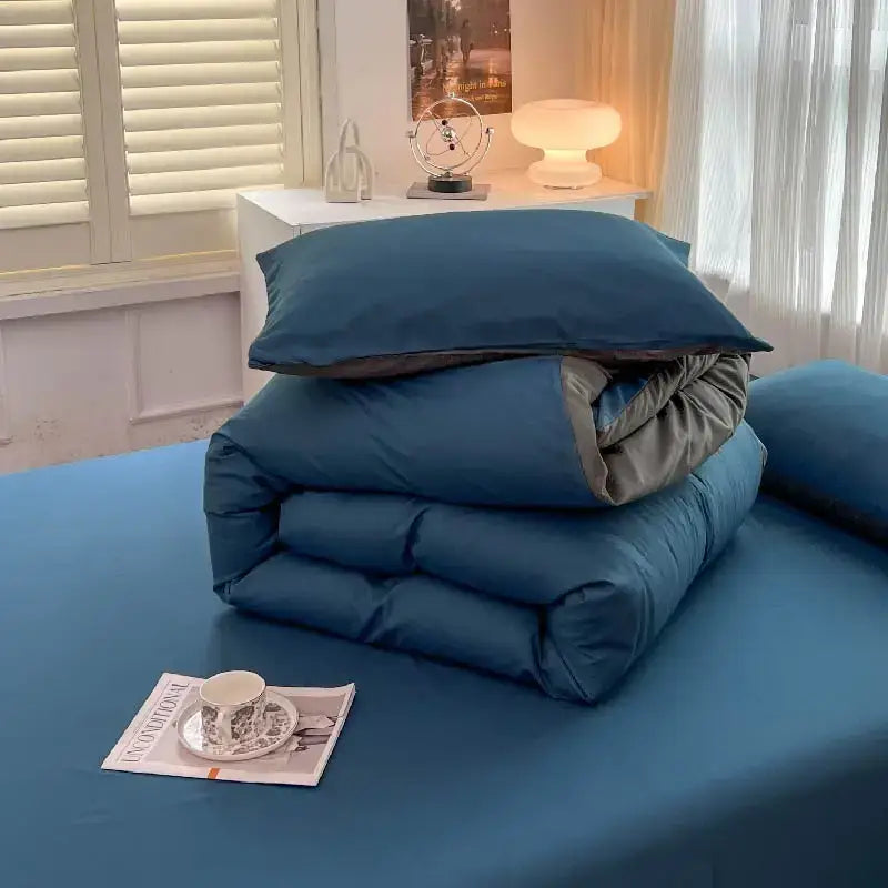 Blue quilted solid color brush fabric duvet cover with gray inner lining neatly folded from decorbites bedding set