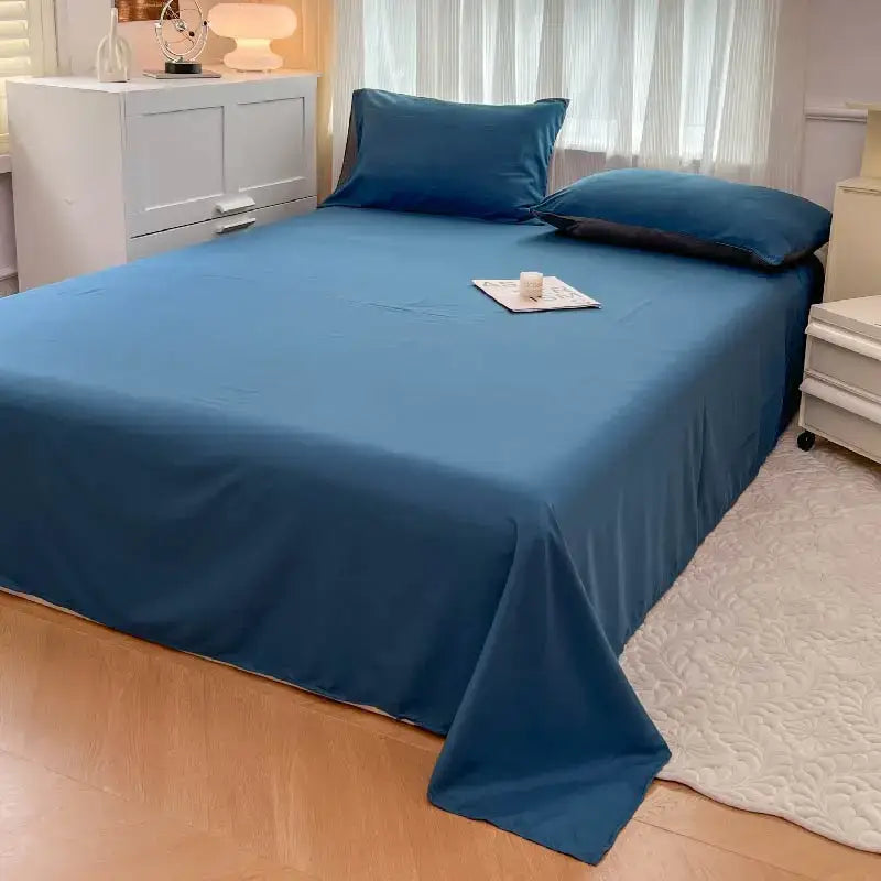 Decorbites™ solid color brush fabric duvet cover set in deep blue neatly draped over a made bed with matching pillowcases