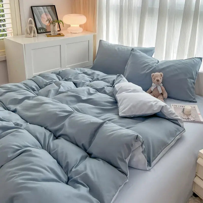 Soft light blue quilted duvet cover set in solid color brush fabric with matching pillows and plush teddy bear