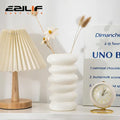White ceramic spiral white vase with stacked rounded ridges and smooth finish for home decoration by DecorBites