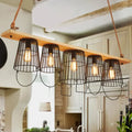 DecorBites traditional barrel metal island pendant light with five black wire cage shades and wood accents for dining room