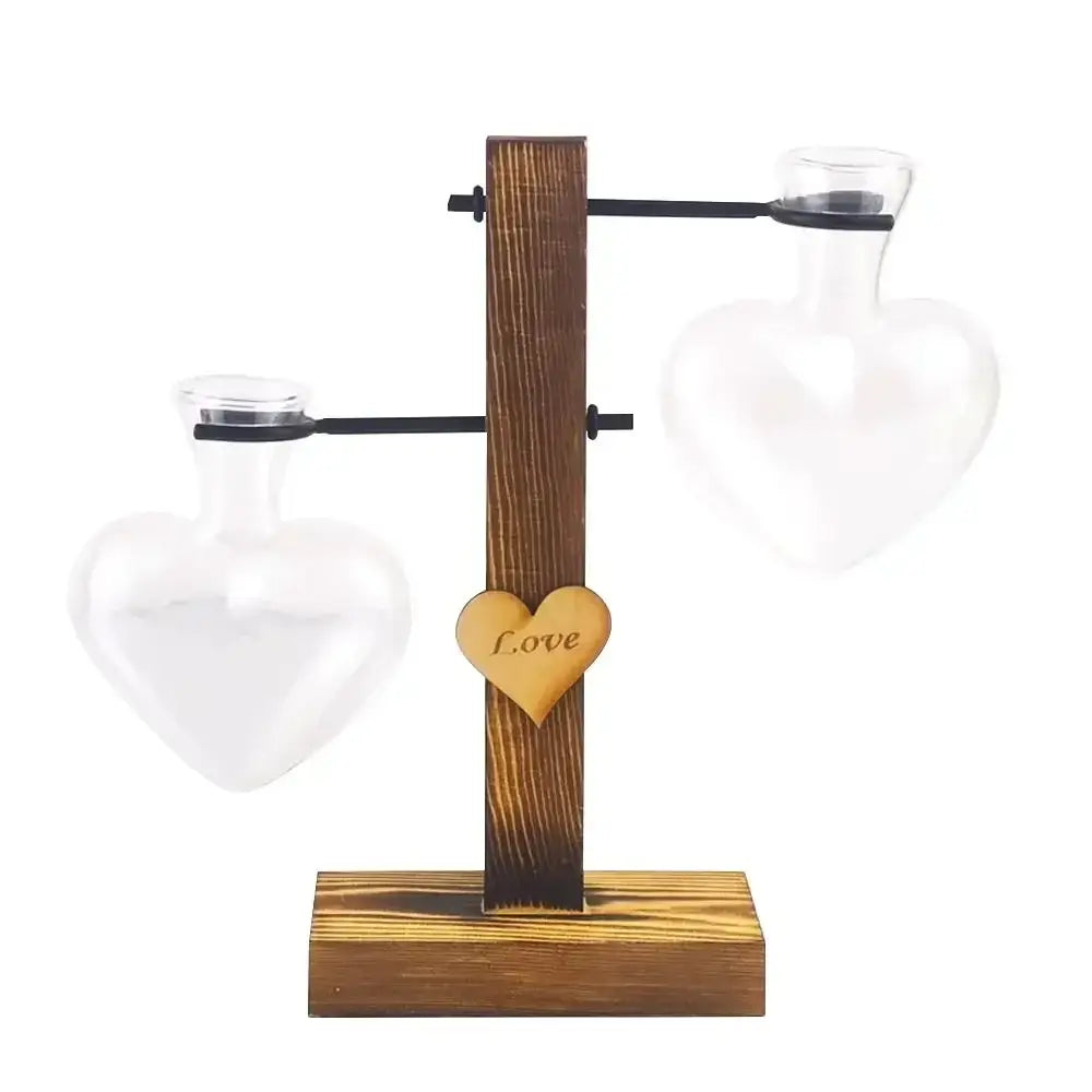 DecorBites™ transparent heart-shaped glass vase with love charm on rustic stand for avocado seed starter use