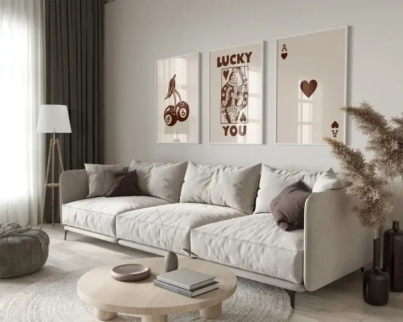 Beige upholstered sectional sofa with dark brown throw pillows beside decorbites™ trendy retro wall art posters 3-piece set