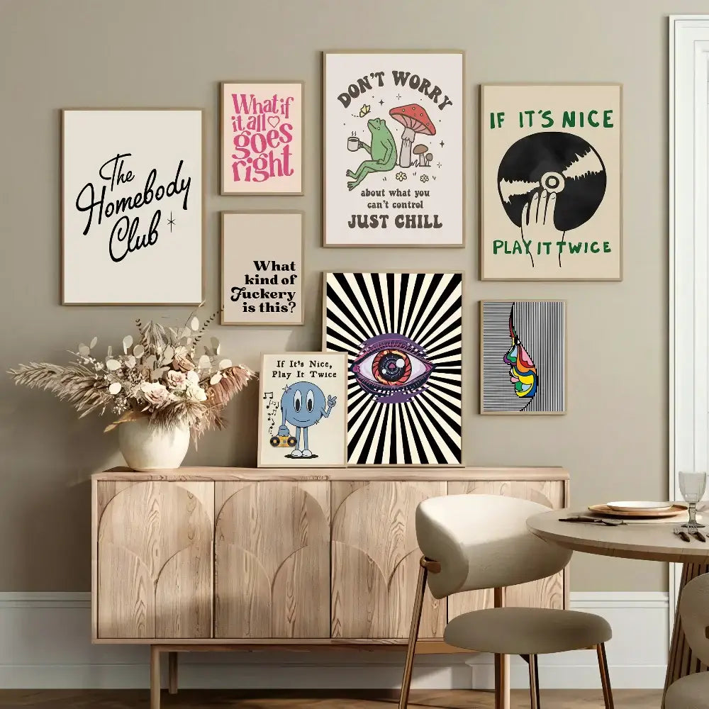 A collection of framed retro pink cartoon print posters arranged above a wooden console table for wall decor