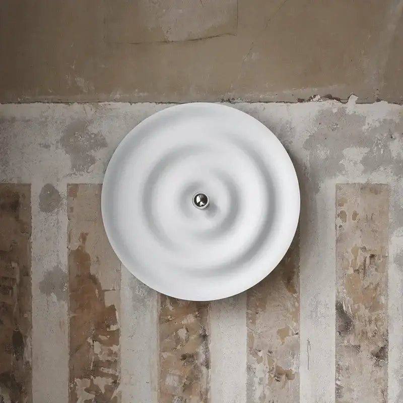 White nordic bauhaus ceramic wall sconce with concentric ridges and central metallic sphere bauhaus round lamp