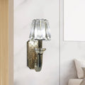 Elegant brass and crystal tapered cone sconce light with crystal-encrusted curved arm and polished brass backplate for bedroom